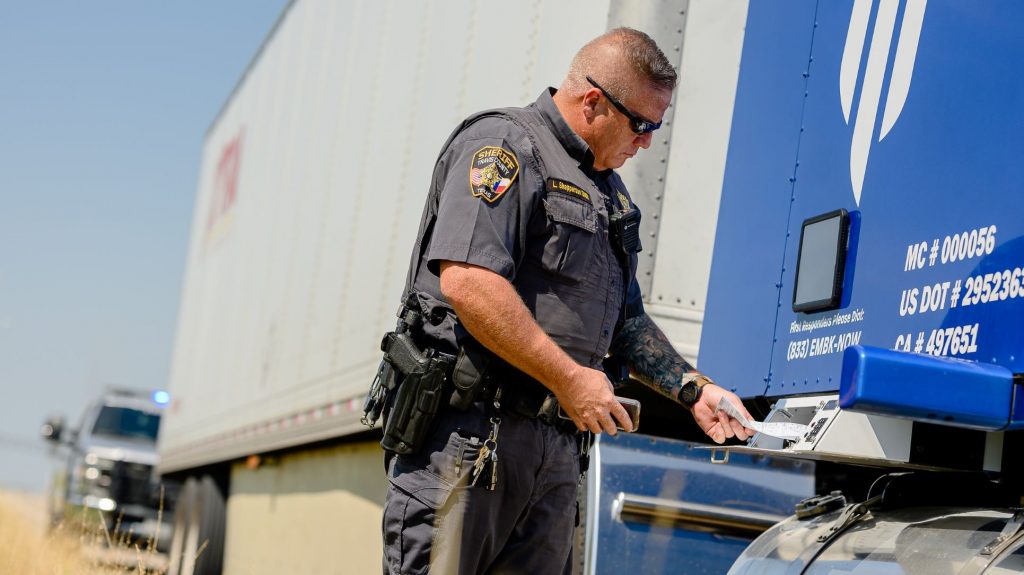 Law enforcement officer accessing Embark Trucks' documentation external lockbox.