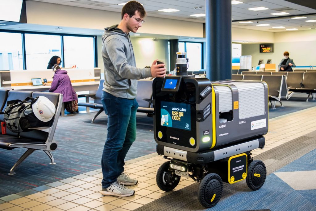 Ottonomy's Ottobot delivering an order to a Pittsburgh International Airport traveler.